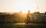silhouette of human figure riding bike